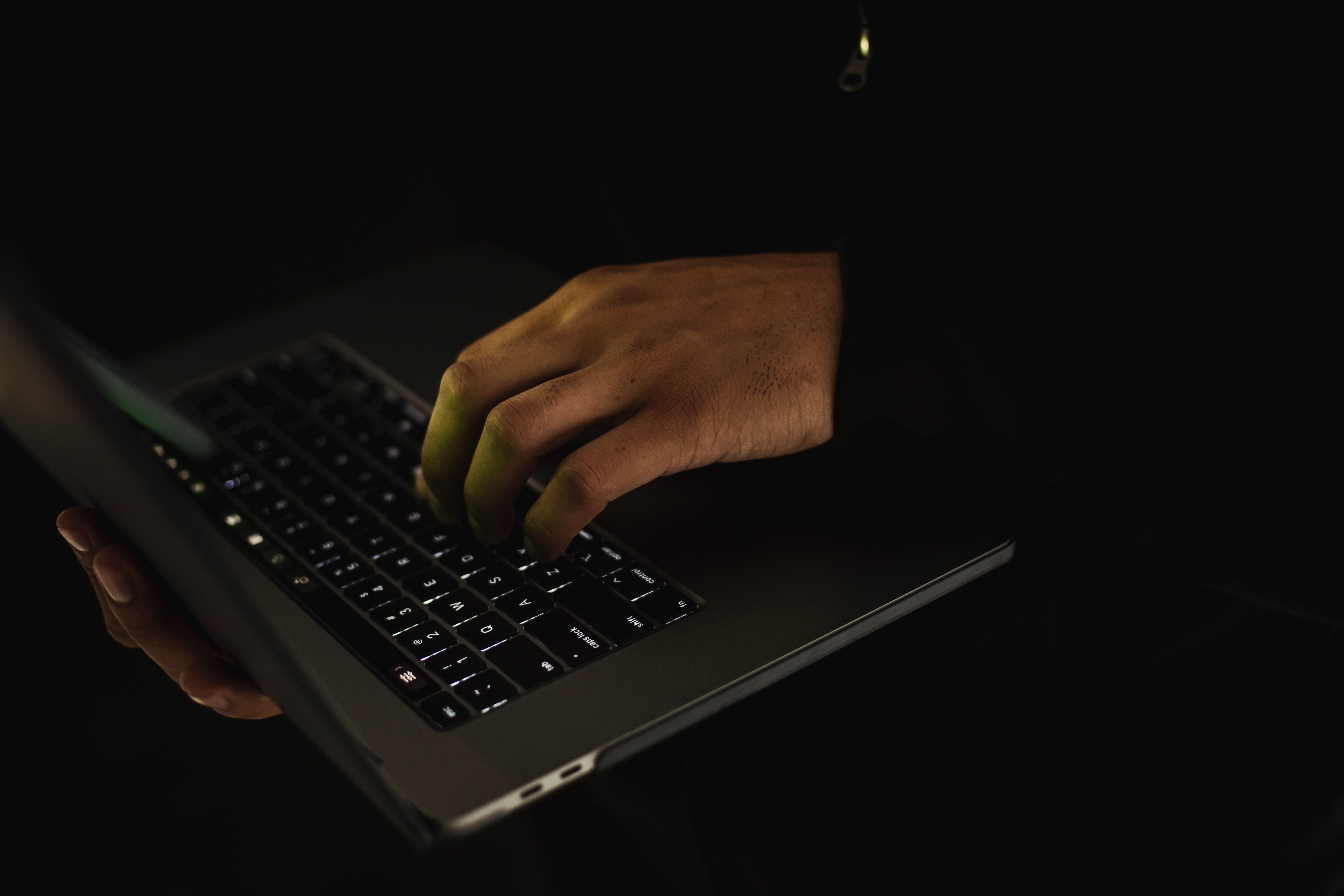 A programmer coding on a laptop